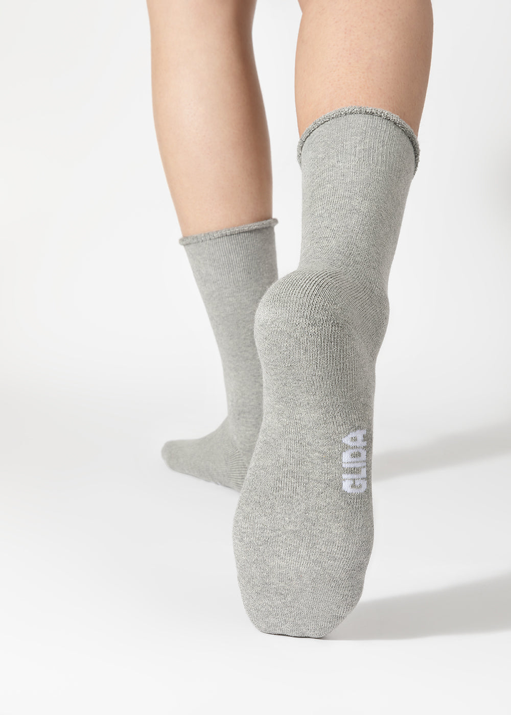 GLIDA Light Grey crew socks on-model close-up showing GLIDA branding on side – heathered grey cotton mid-calf socks